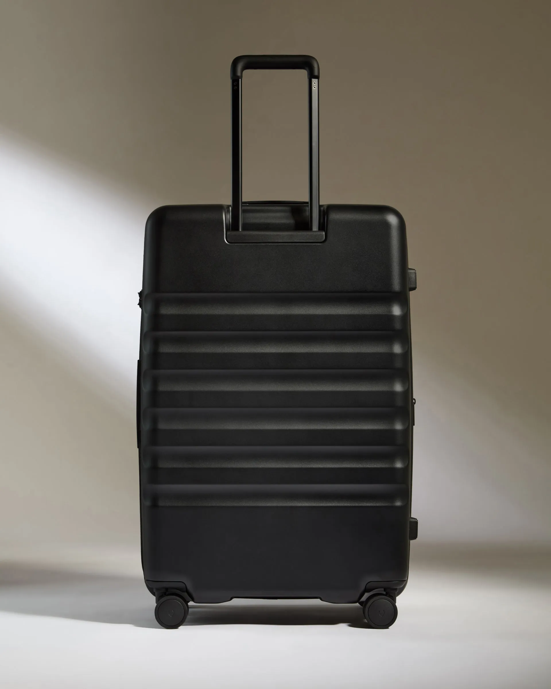 Large Suitcase in Black - Icon Stripe