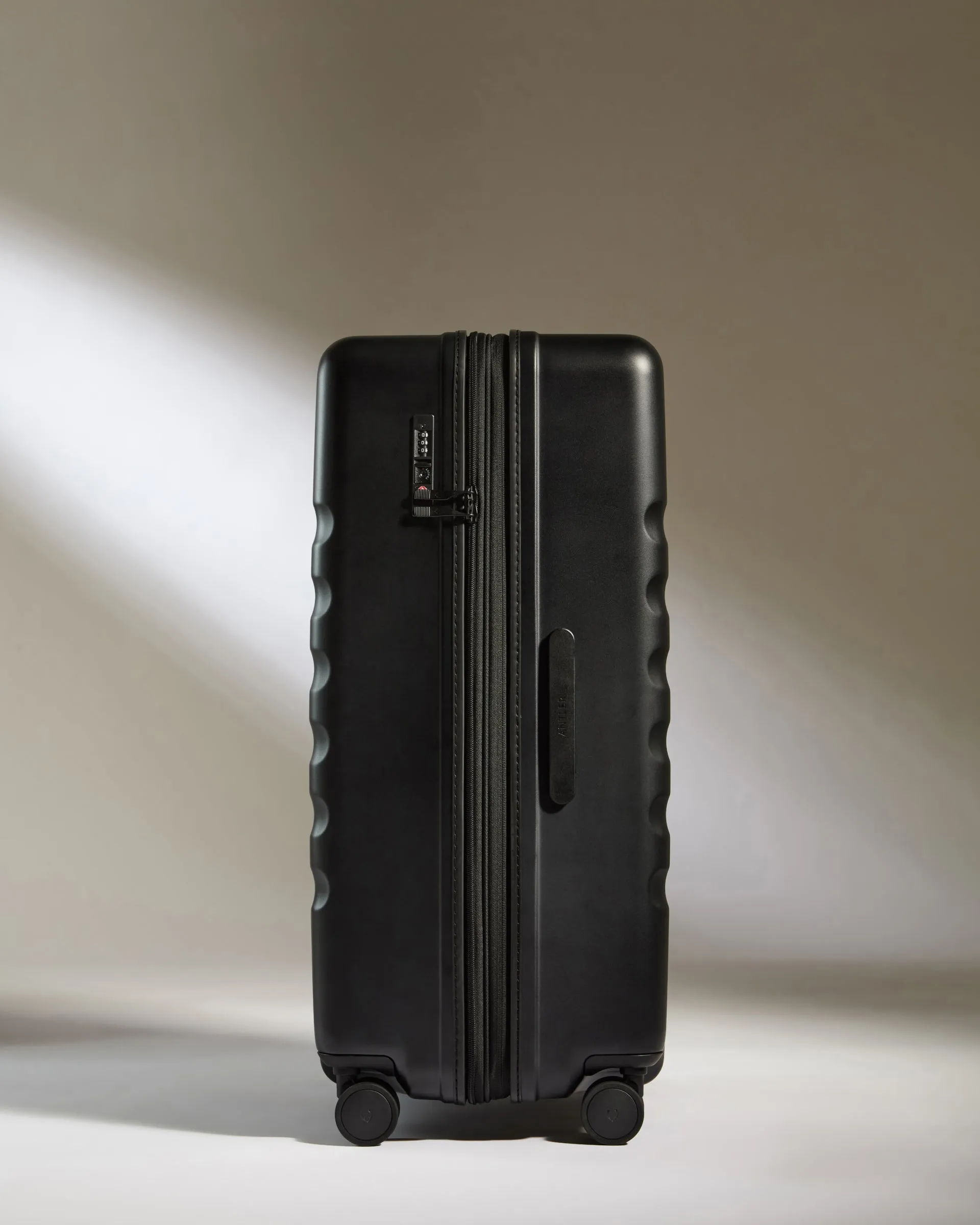 Large Suitcase in Black - Icon Stripe