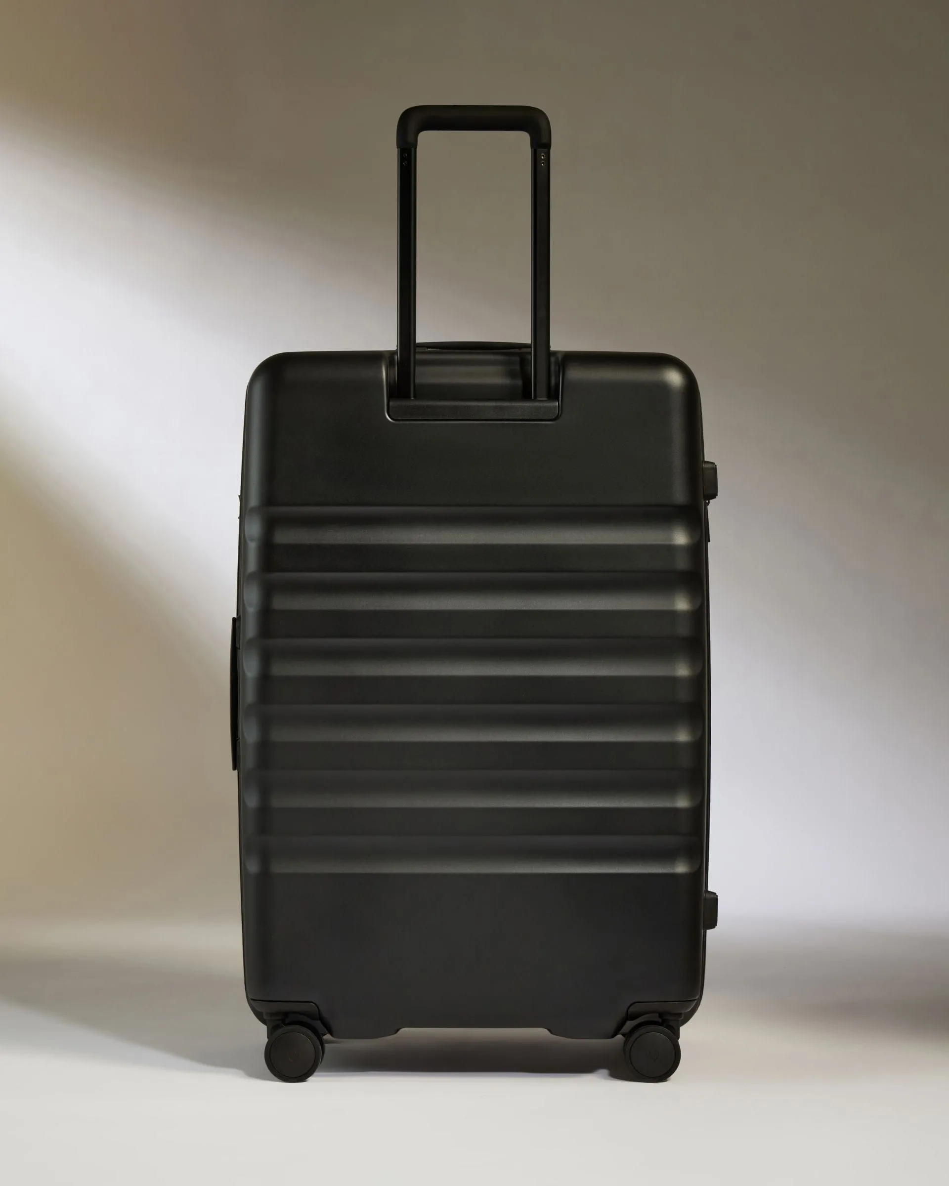 Large Suitcase in Black - Icon Stripe