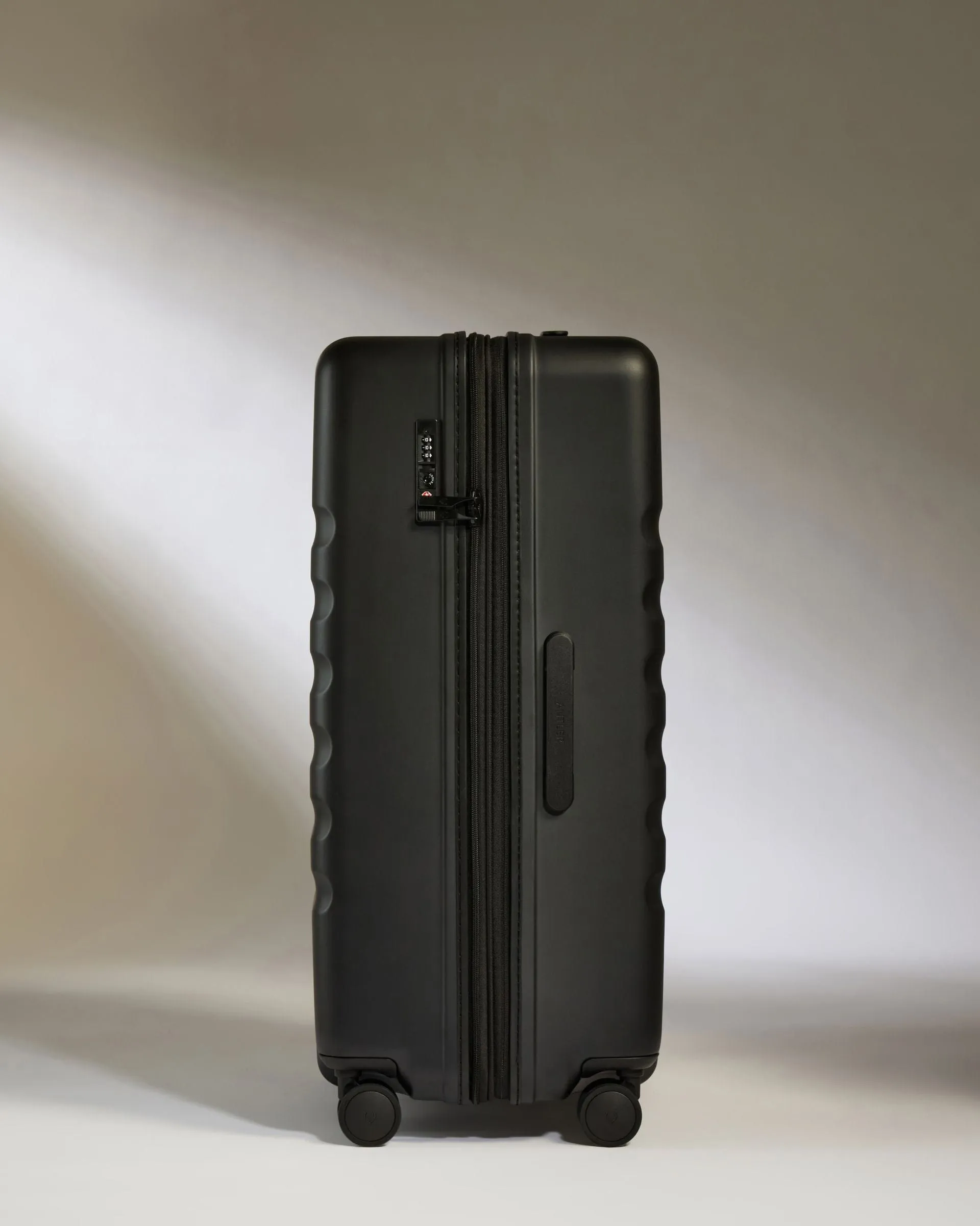 Large Suitcase in Black - Icon Stripe