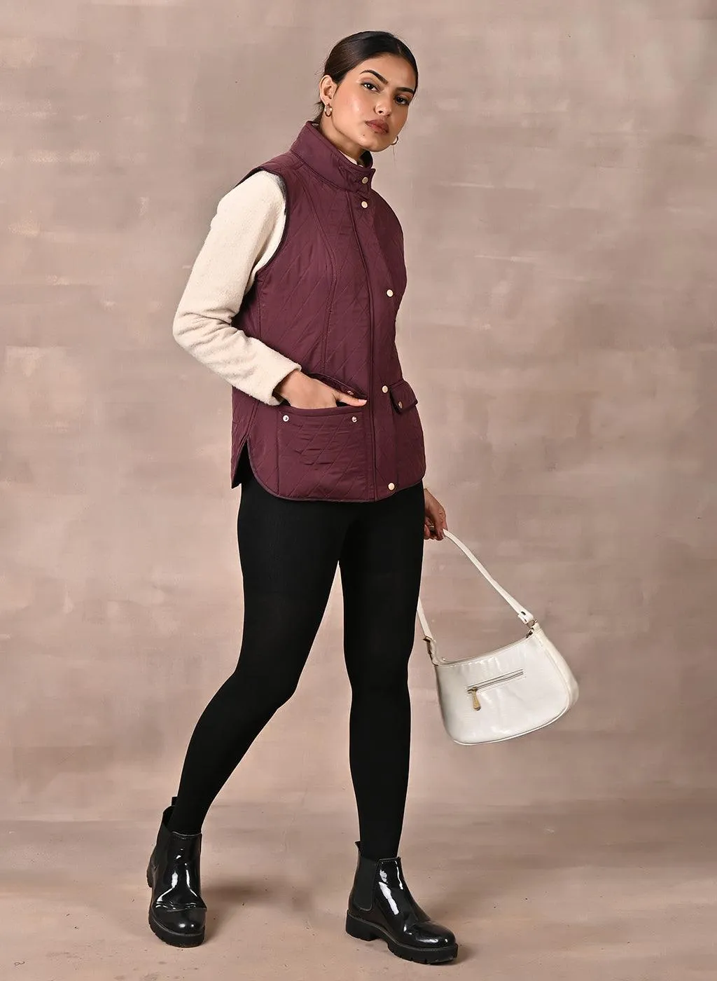 Maroon Solid Sleeveless Quilted Jacket With Rivets Detail & Curved Hem
